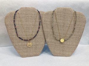 two displays of layered joya necklaces