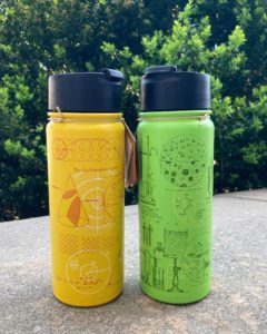 two plastic reusable water bottles, the left is yellow with math drawings and the right is green with chemistry drawings