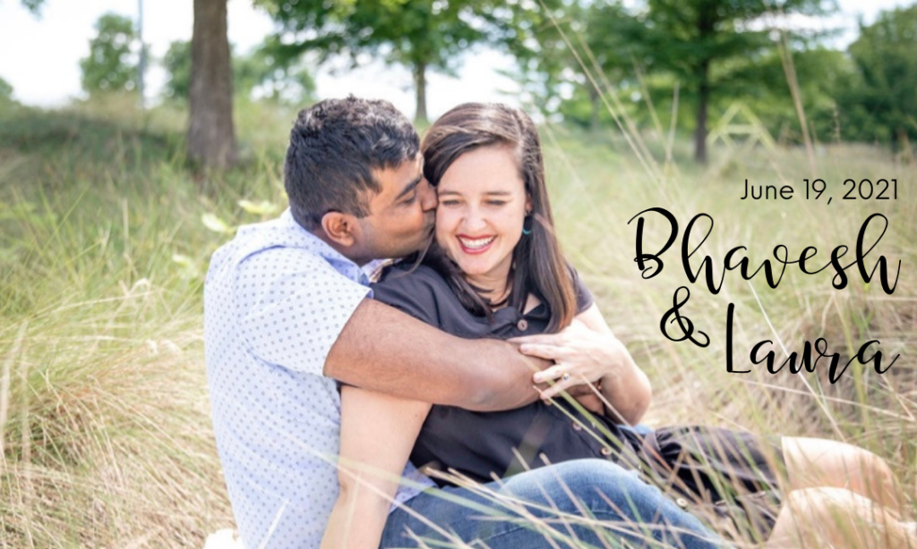 Engagement photo of Laura and Bhavesh sitting down in a field. Bhavesh is kissing Laura's cheek.
