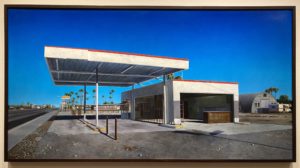 a painting of an abandoned gas station on the side of a road