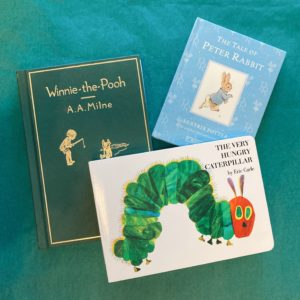 a collage of three books: Winnie the Pooh (left), Peter Rabbit (top right,) and The Very Hungry Caterpillar (bottom right)