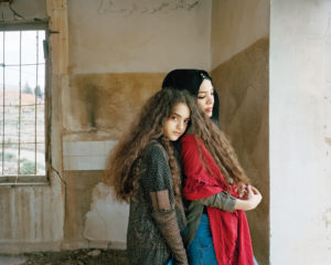 Sarah and Aya from Lebanon standing together in an empty room