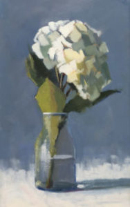 single white hydrangea in a glass vase