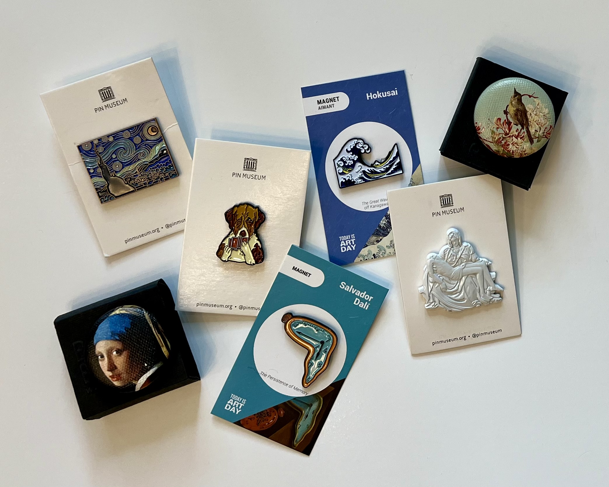 a variety of art pins and magnets