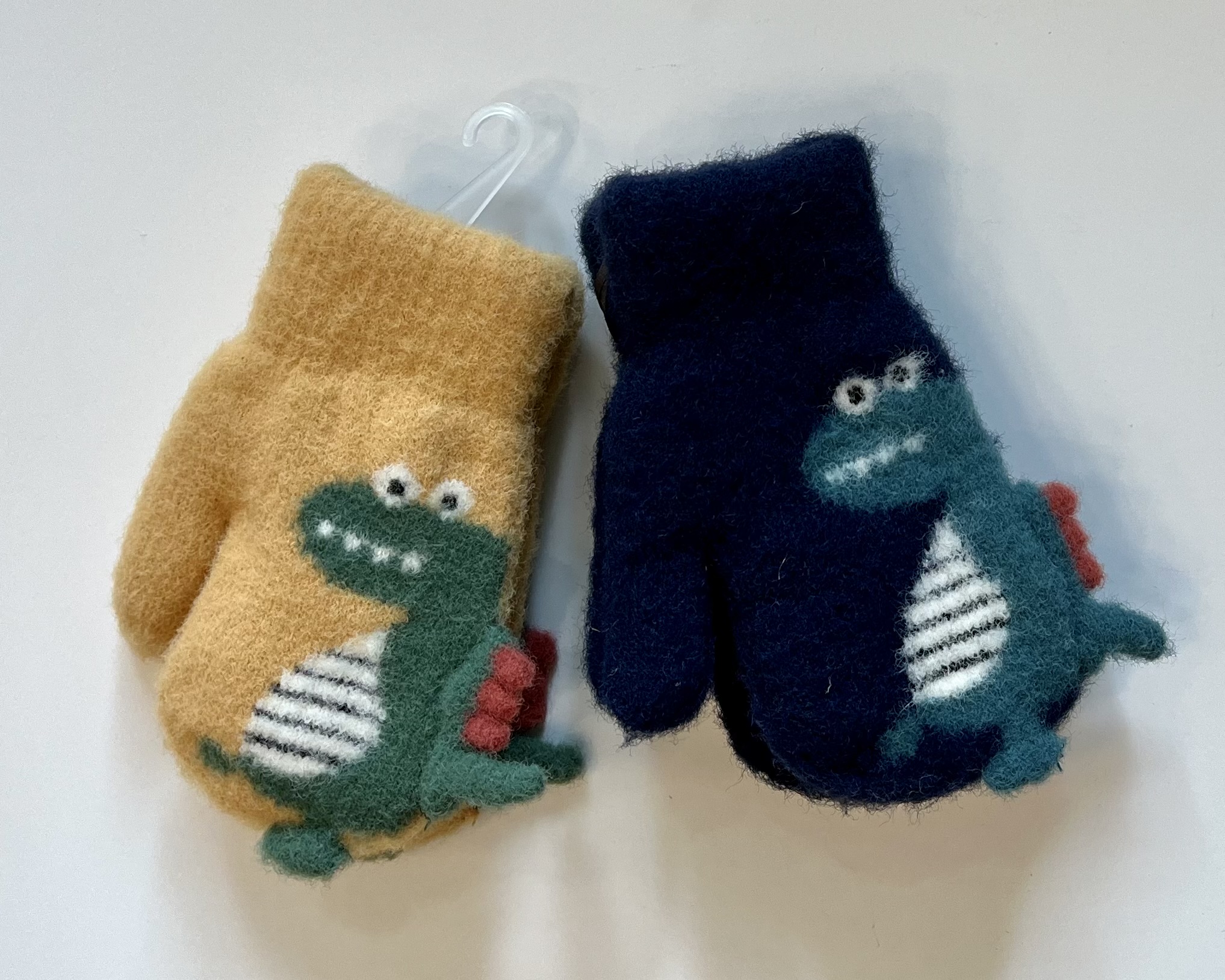 two pairs of dino mittens